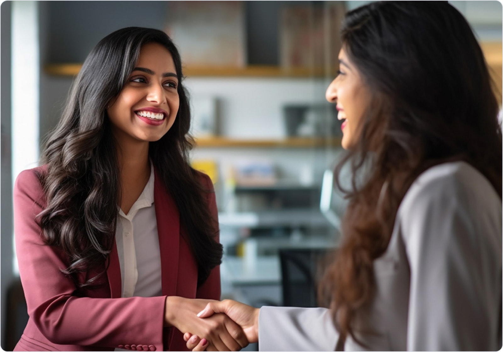 Two Orkla India colleagues greeting each other with a handshake in the office.