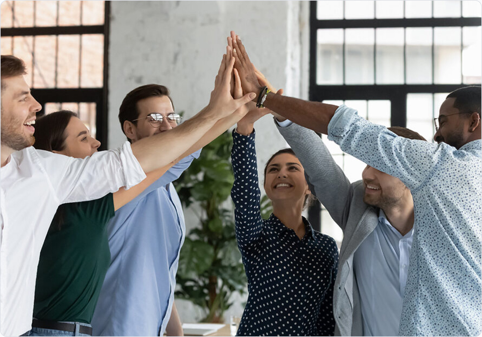 Orkla India team members celebrating together with a group high five.