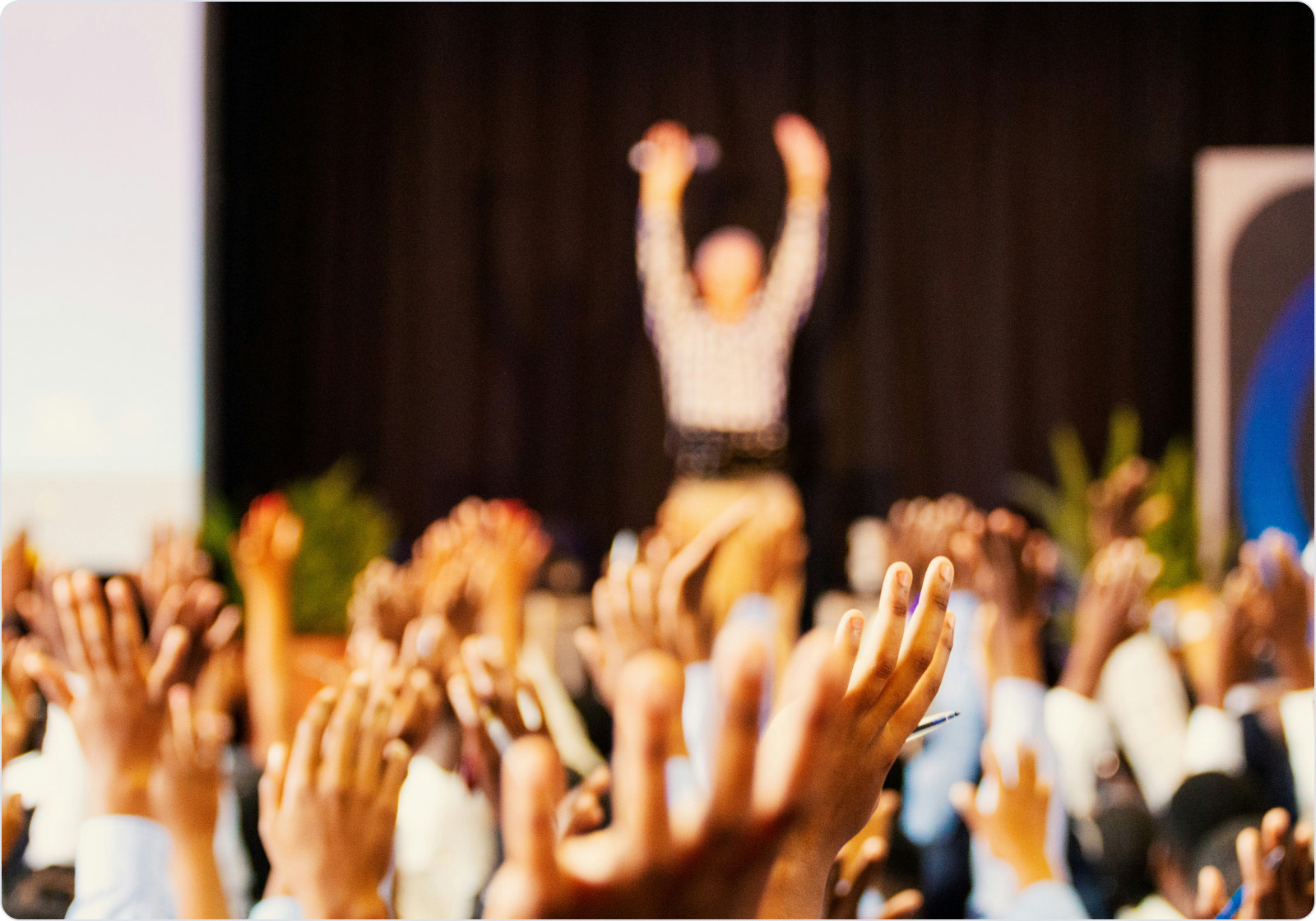 Colleagues applauding with raised hands at an Orkla India recognition event.